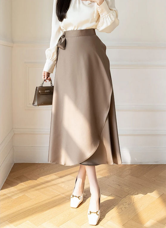 Willa wearing a taupe satin wrap midi skirt with bow detail